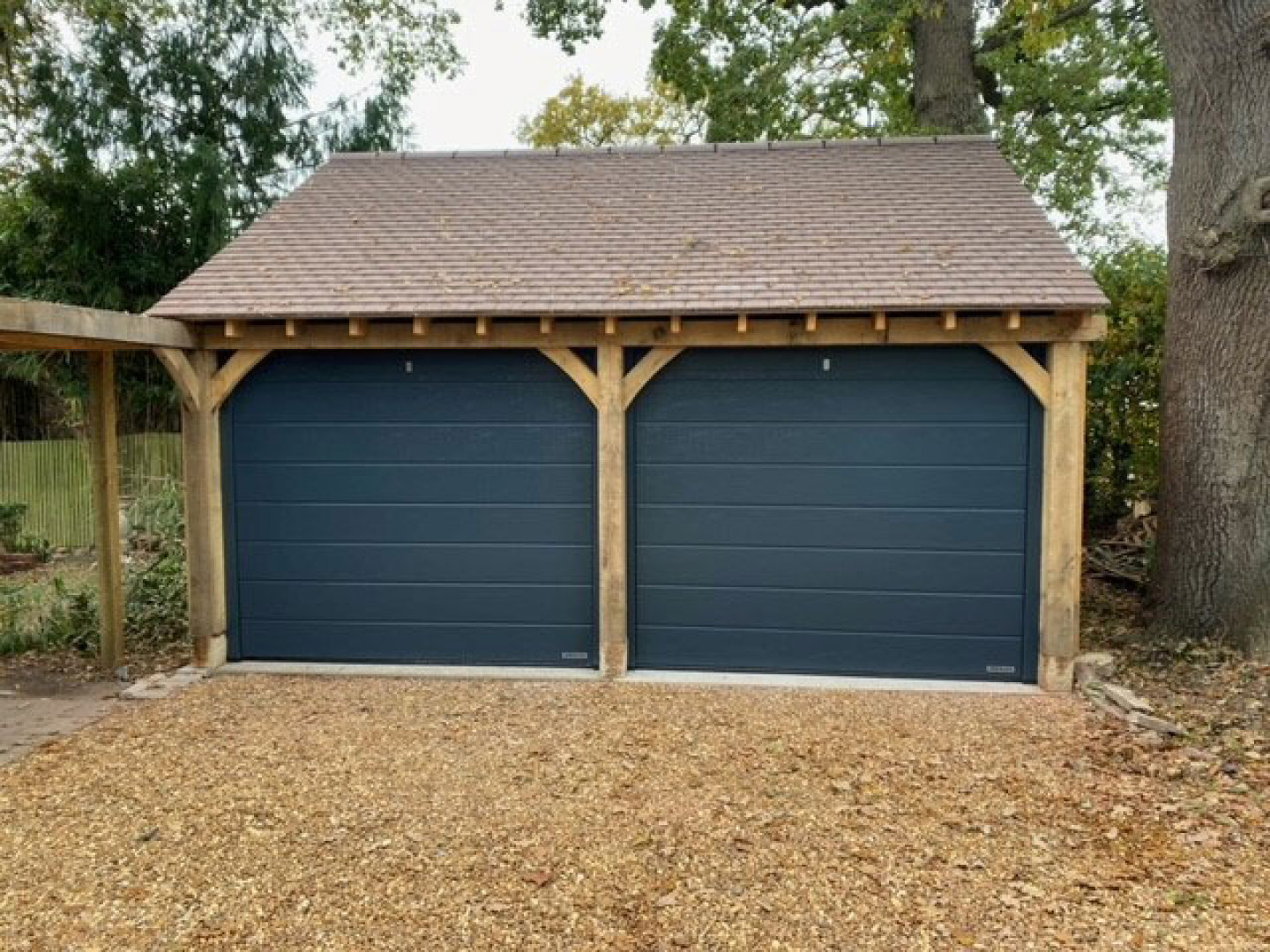 VB Garage Doors melding old and new, with two Linear Medium sectional garage doors installed in the Dorset countryside.